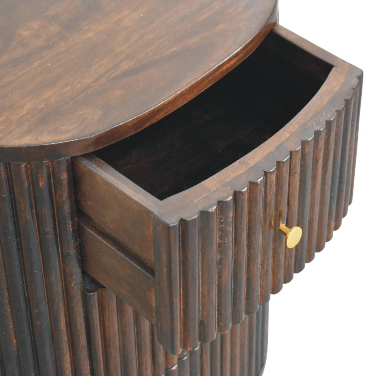 High-angle view showing the top drawer pulled open on a fluted velvet mocha bedside table, revealing the dark wooden interior compartment.