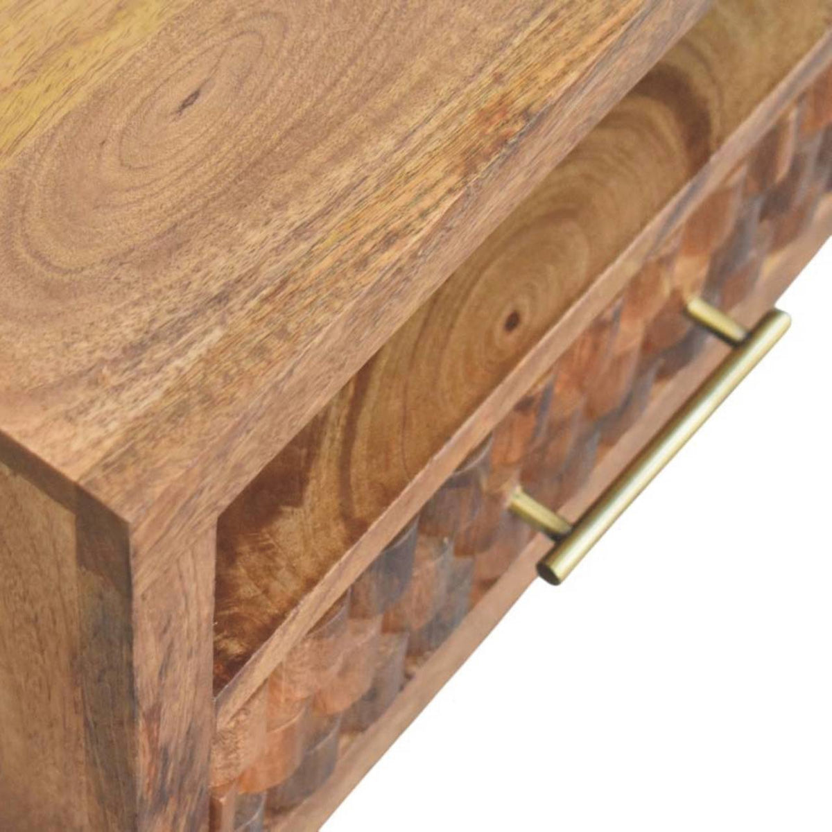 Close-up angled view of the pulled-out drawer, emphasizing the deeply carved geometric block texture on the golden teak mango wood.