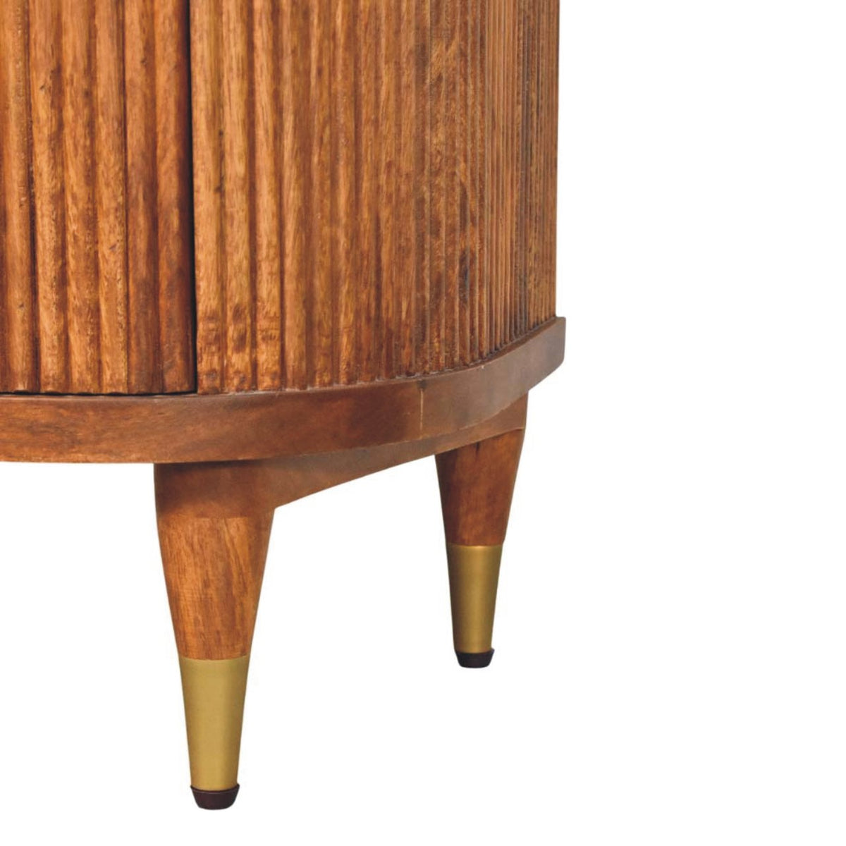 Detail shot of the tapered wooden legs with brass caps supporting a solid mango wood ribbed bedside table.