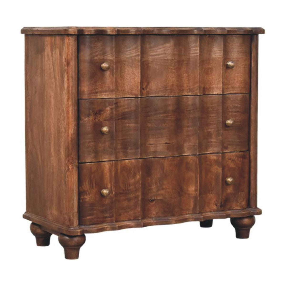 Angled left perspective of a solid mango wood chest in roasted almond, showcasing the wavy drawer panels, scalloped base, and bun feet.