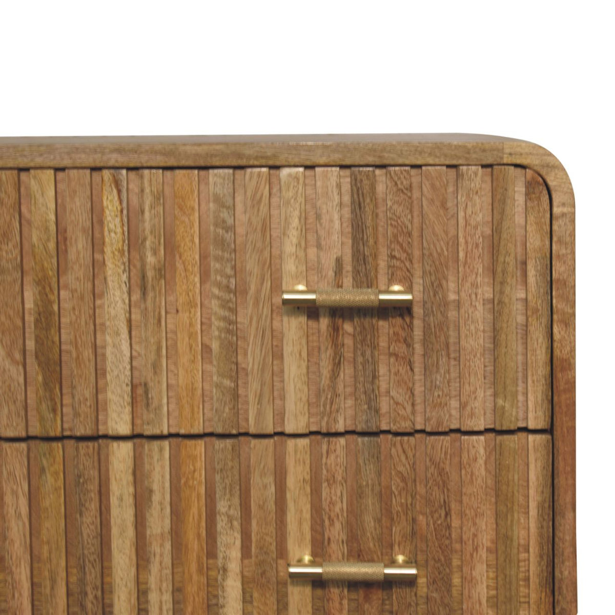 Close-up detail of a natural oak finish mango wood chest, showing the vertical ridged texture of the drawer front and a knurled brass bar handle.