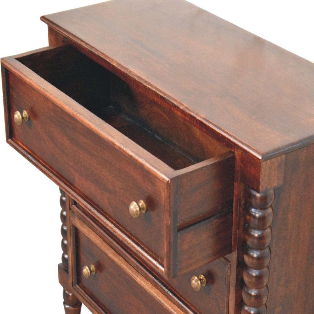 High-angle view showing the top drawer pulled open on a Winewood Oak spindle chest, revealing the interior wooden storage compartment.