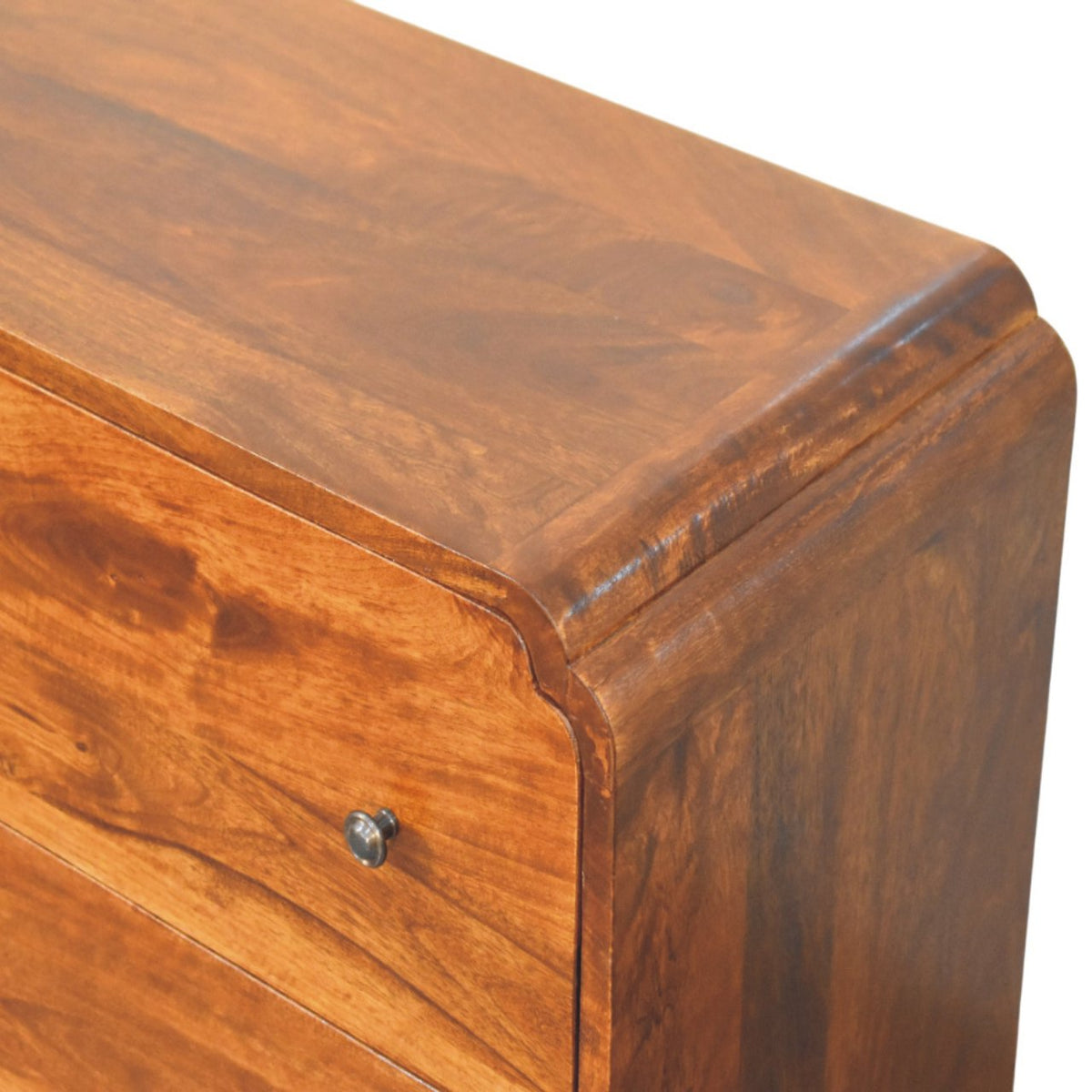 Close-up of a wooden drawer of a chest of drawers with a visible knob on a white background