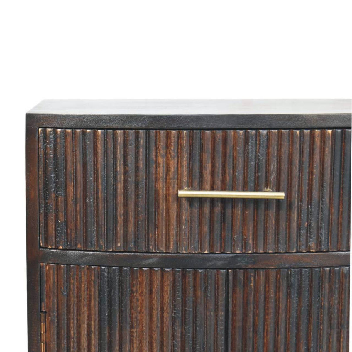 Close-up detail of the vertical fluted wood texture and a sleek brass bar handle on the top drawer of a velvet mocha bedside table.
