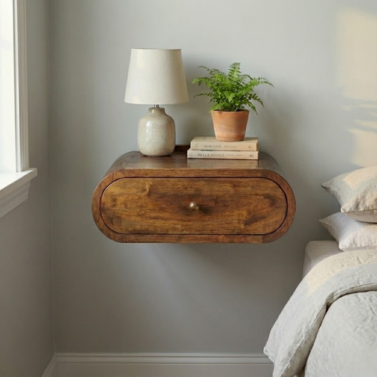 Wall mounted round chestnut bedside table styled in a bedroom setting
