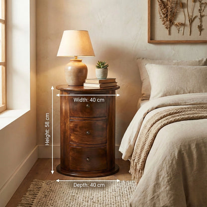 Wooden nightstand with lamp and books in a bedroom setting, showing dimensions.