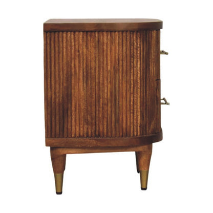 Straight-on side profile view of a ribbed bedside table in amber oak, showcasing the textured side panel and curved front profile.