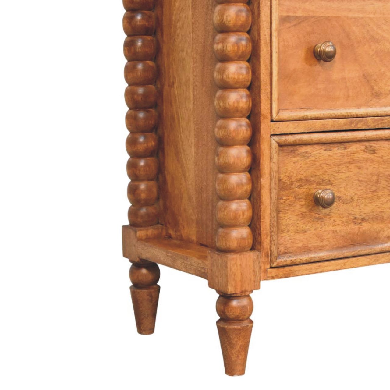 Lower left angle of the Chest of Drawers highlighting carved spindle legs