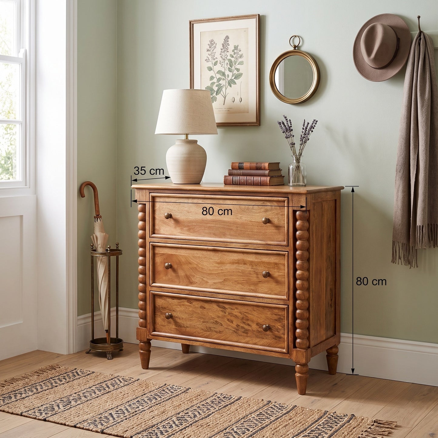 A wooden three-drawer dresser in a warm medium brown finish, styled with a table lamp, books, and a vase in a decorated room. White dimension lines and text overlay indicate measurements of 80 cm width, 35 cm height, and 80 cm depth.