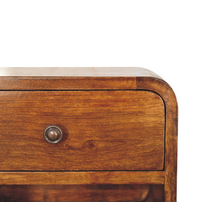Close-up detail of the smooth rounded top right corner, rich wood grain, and small dark metal knob on a chestnut floating bedside table.