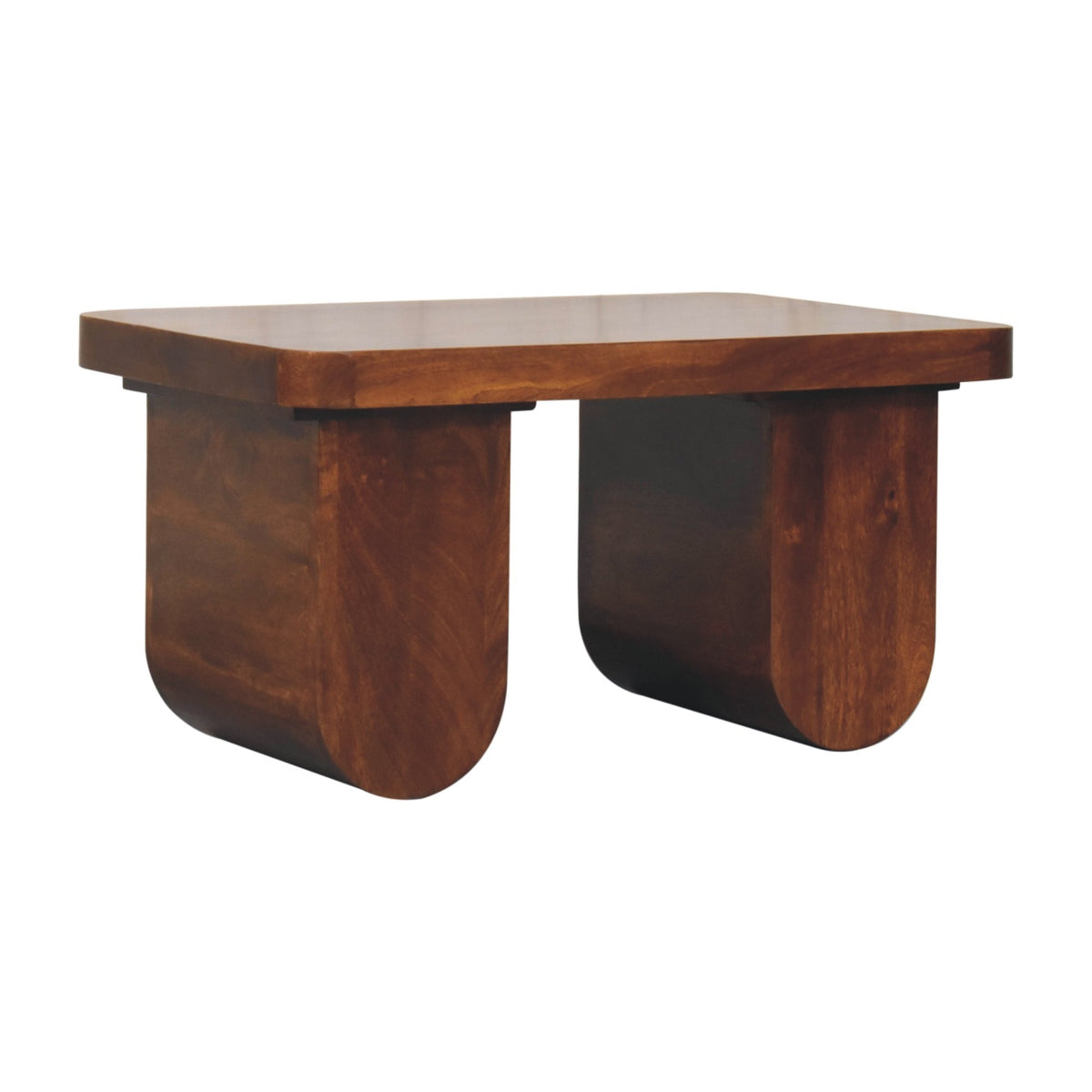 Angled left perspective of a chestnut chunky coffee table, showcasing the thick solid mango wood construction and rounded leg profile.