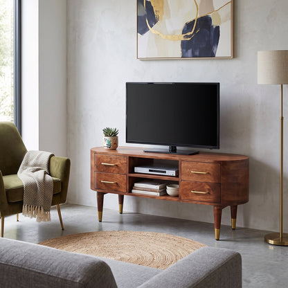 Curved 2-drawer media unit in solid mango wood, Winewood Oak finish – lifestyle setting