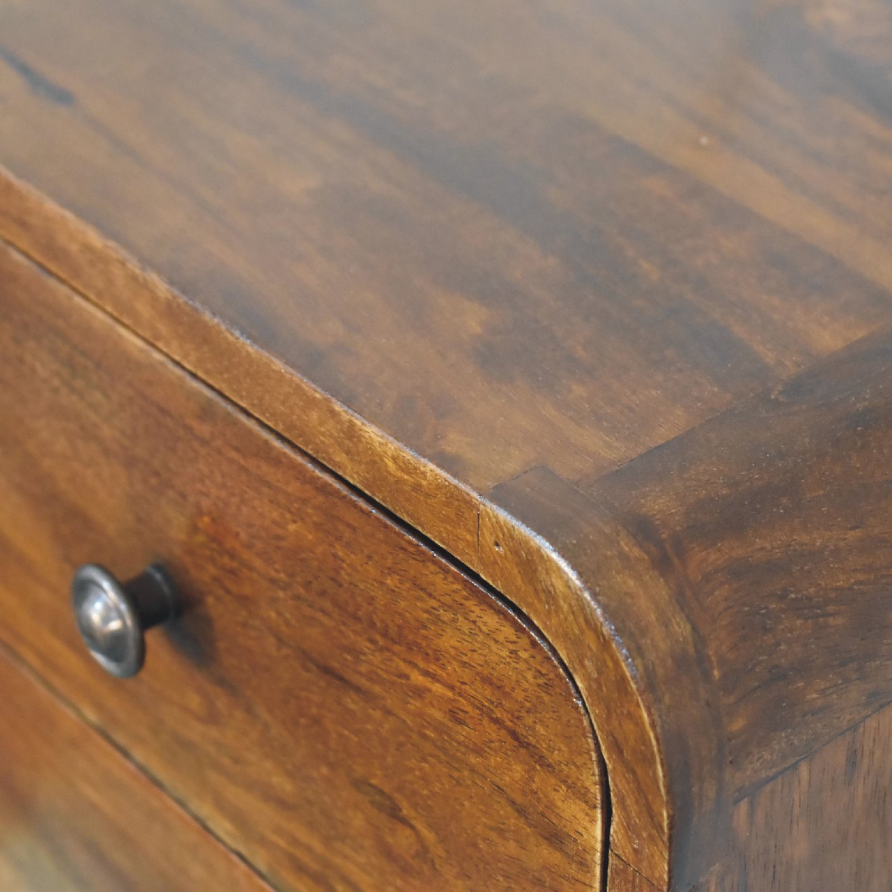 Close upper right angle of Floating Mini Chestnut Bedside showing mango wood grain and finish detail
