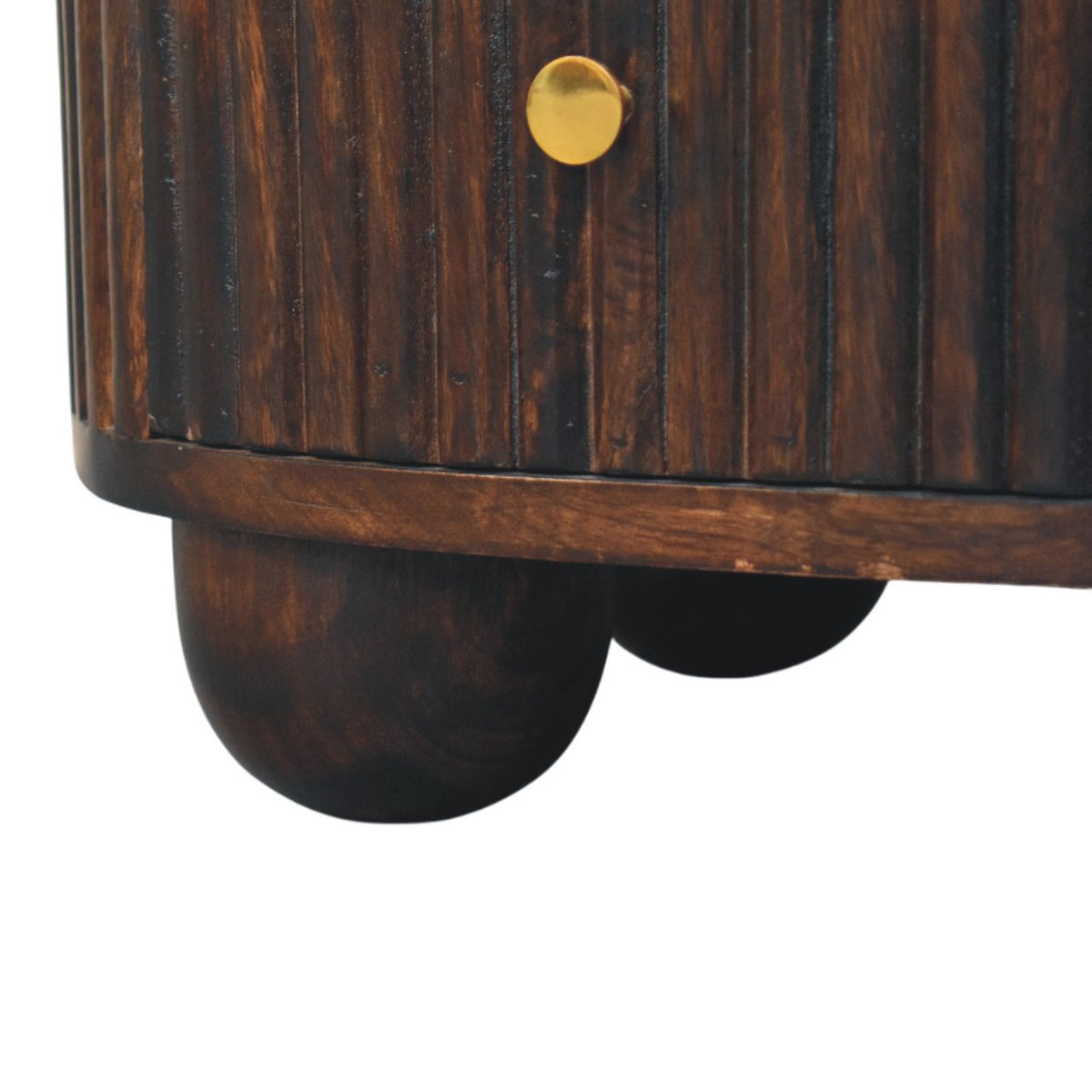 Detail view of the solid wood round bun feet supporting a velvet mocha fluted mango wood bedside table.