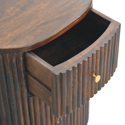 High-angle view showing the top drawer pulled open on a fluted velvet mocha bedside table, revealing the dark wooden interior compartment.