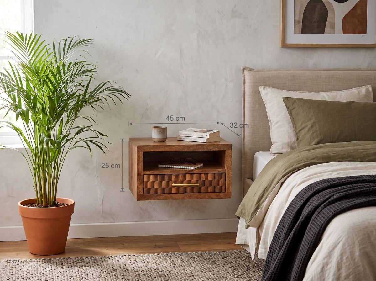 Lifestyle image of a golden teak solid mango wood wall-mounted bedside table next to a bed, with text overlays showing 45 cm width, 32 cm depth, and 25 cm height.