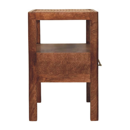 Side view of a honey caramel solid mango wood bedside table, showing the solid side panel next to the drawer.