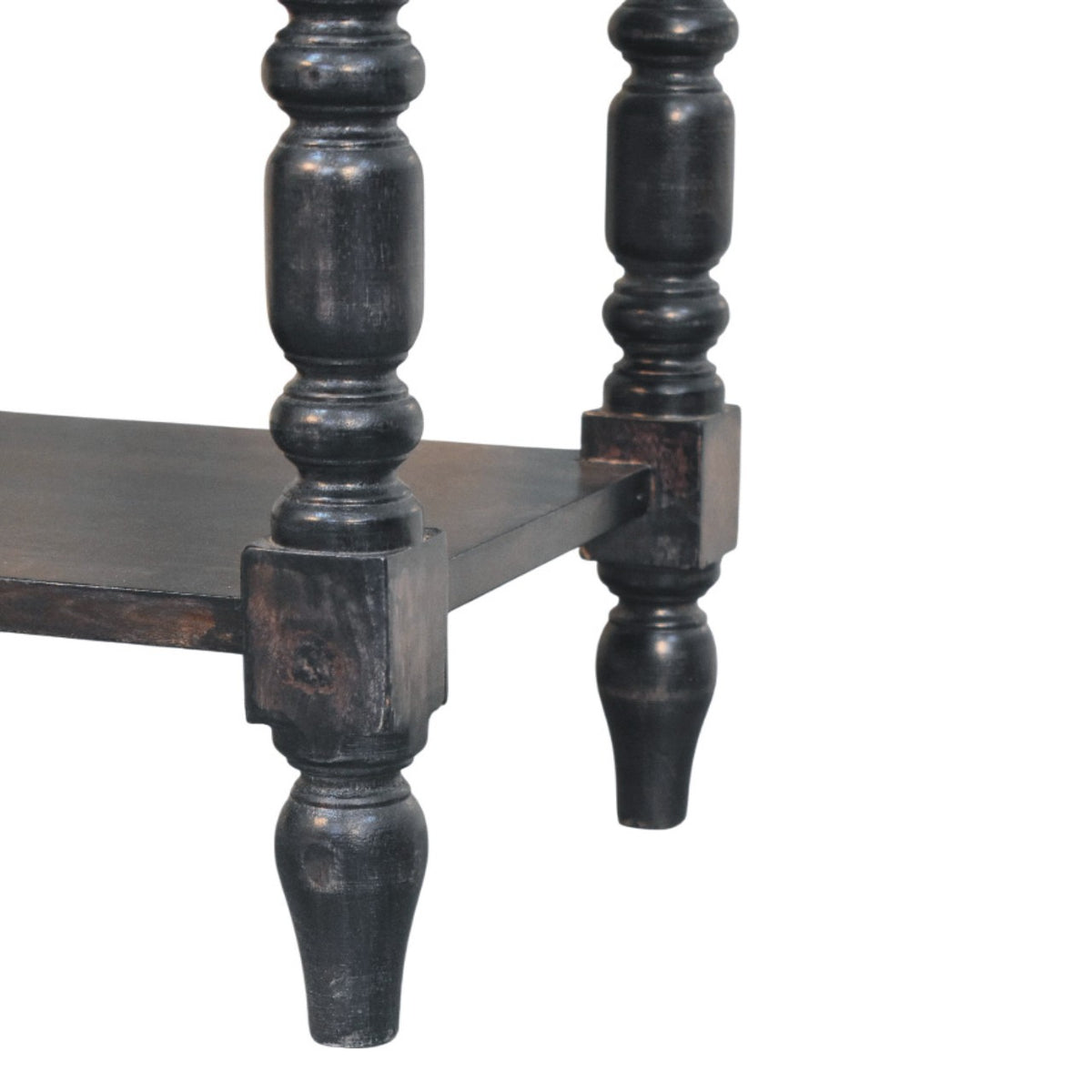Close-up detail of the decorative turned legs and the bottom shelf corner block joining on a carbon ash solid mango wood side table.