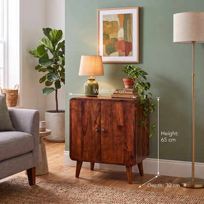 A wooden cabinet with two doors is shown in a styled living room setting with overlaid dimension lines indicating width 55 cm, height 65 cm, and depth 30 cm.