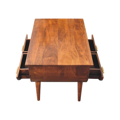 Wooden coffee table with four drawers on a white background