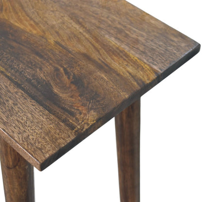 Close-up of a wooden writing desk with a rustic finish.