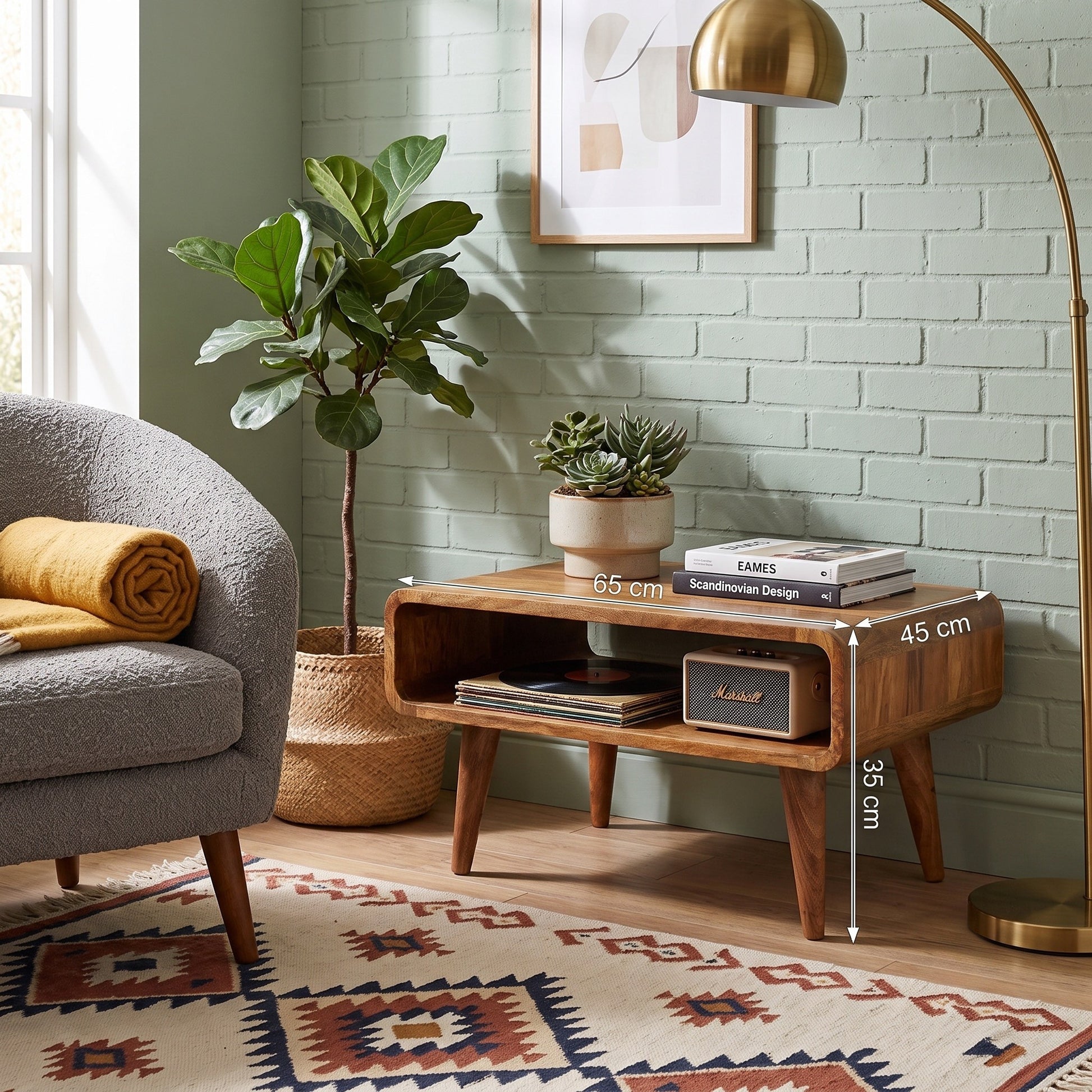 A wooden media unit with an open shelf and mid-century tapered legs, shown in a styled living room setting. White dimension lines overlay the table, indicating 65 cm length, 45 cm width, and 35 cm height.