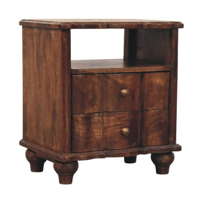 Angled left perspective of a roasted almond finish bedside table, highlighting its wavy panelled drawer fronts, open shelf, and turned bun feet.