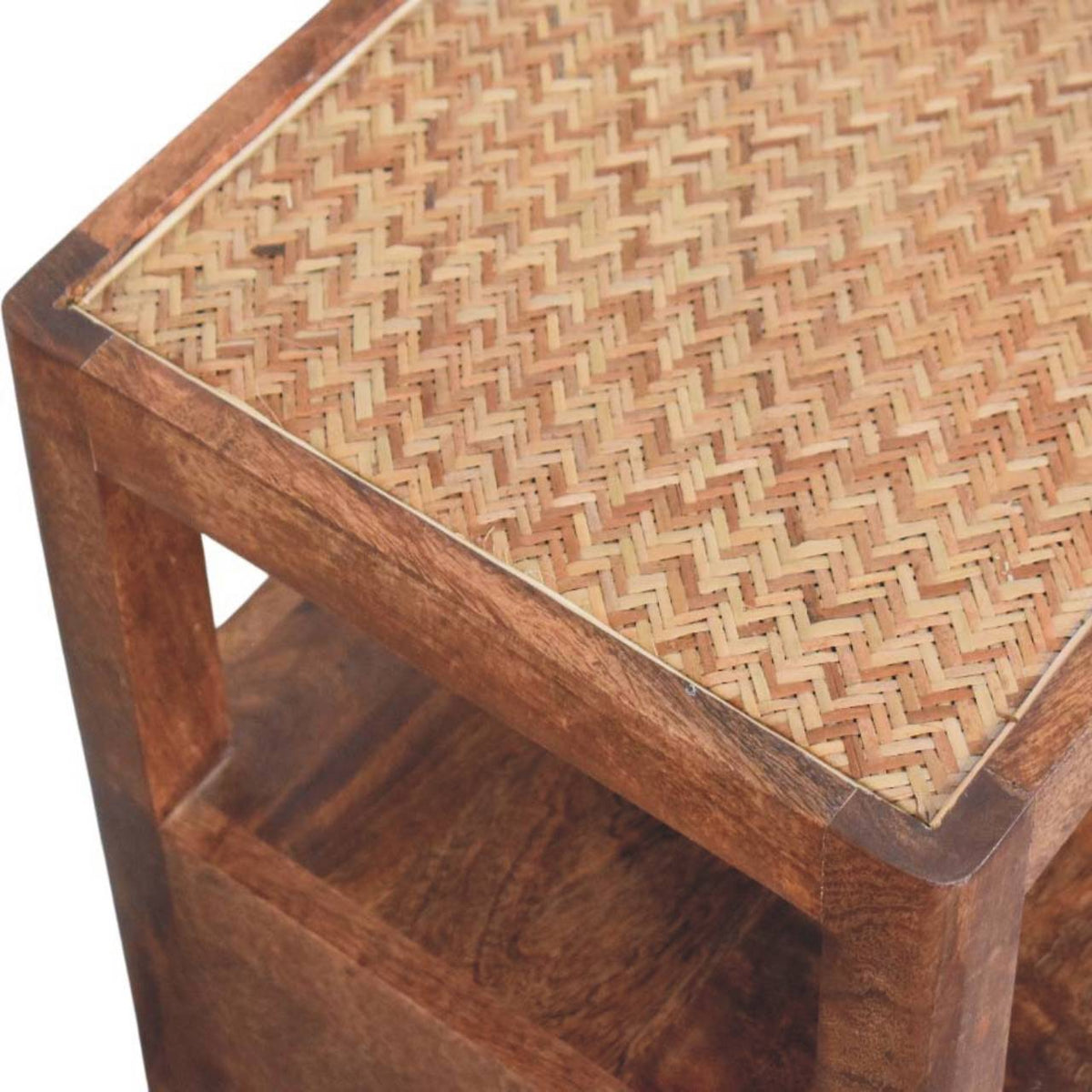 Detail shot of the woven rattan pattern and the solid wood corner joinery on the top of a honey caramel bedside table.