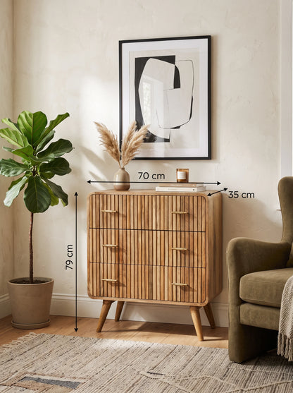 Lifestyle image of a ridged solid mango wood chest of drawers in natural oak with measurement overlays indicating 70 cm width, 35 cm depth, and 79 cm height.