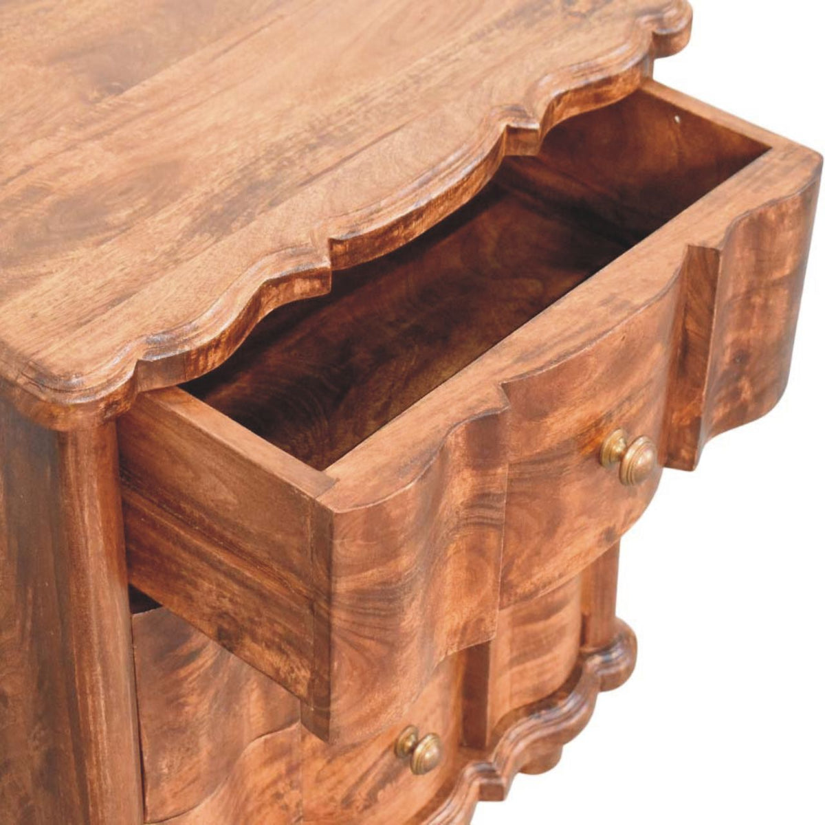 High-angle view showing the top drawer pulled open on a roasted almond solid mango wood bedside table, revealing the wooden interior compartment.