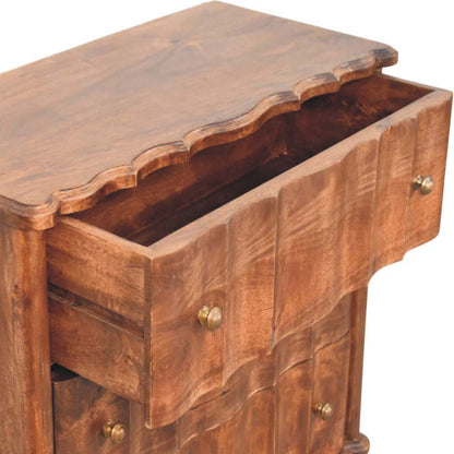 High-angle view showing the top drawer pulled open on a panelled solid mango wood chest in roasted almond, revealing the interior wooden drawer box.