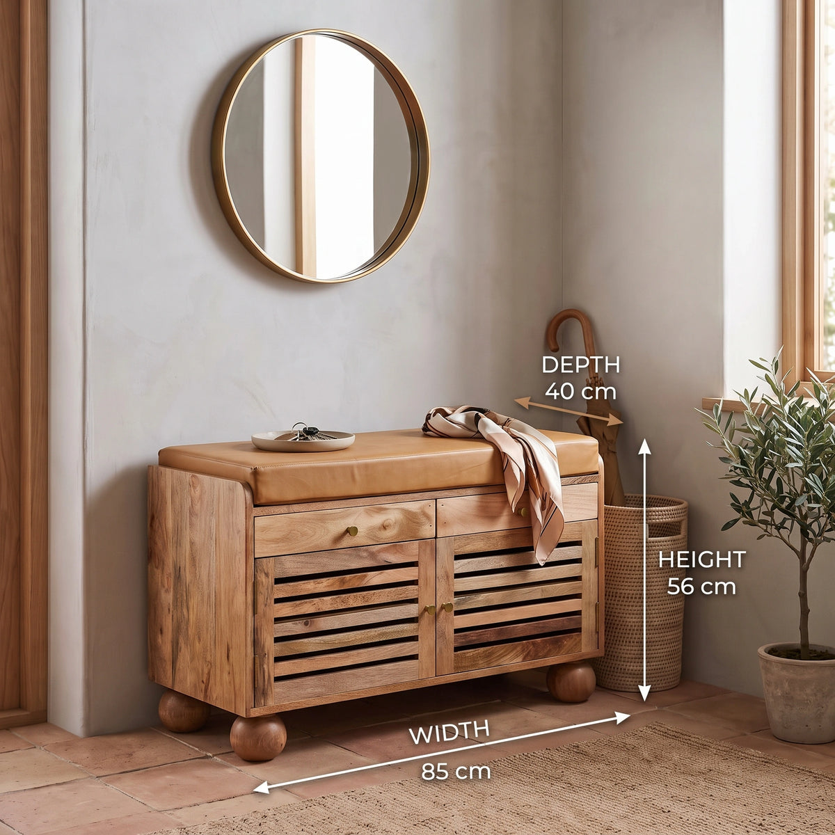 A wooden show rack with a tan cushion, shown in a styled room corner with a mirror, basket, plant, and overlaid dimension labels indicating width 85 cm, depth 40 cm, and height 56 cm.