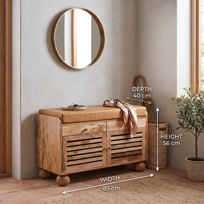 A wooden show rack with a tan cushion, shown in a styled room corner with a mirror, basket, plant, and overlaid dimension labels indicating width 85 cm, depth 40 cm, and height 56 cm.