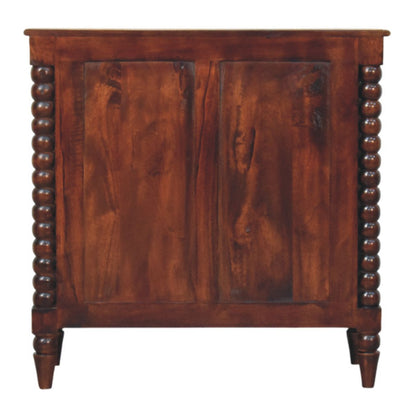 Back view of a Winewood Oak solid mango wood spindle chest, showing the dual-panel wooden back construction.