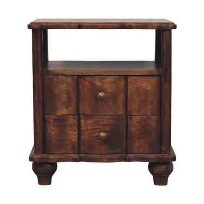 Front view of a solid mango wood bedside table in a roasted almond finish, featuring an open top shelf above two drawers with wavy textured fronts and round metal knobs.