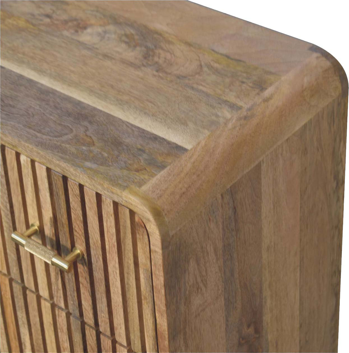 Close-up detail of the smooth, rounded top corner and natural wood grain on a ridged mango wood chest of drawers.