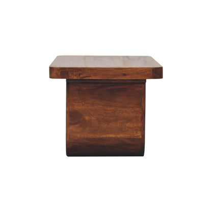 Straight-on side profile view of a chunky solid mango wood coffee table in chestnut, showing the flat outer surface of the U-shaped leg.
