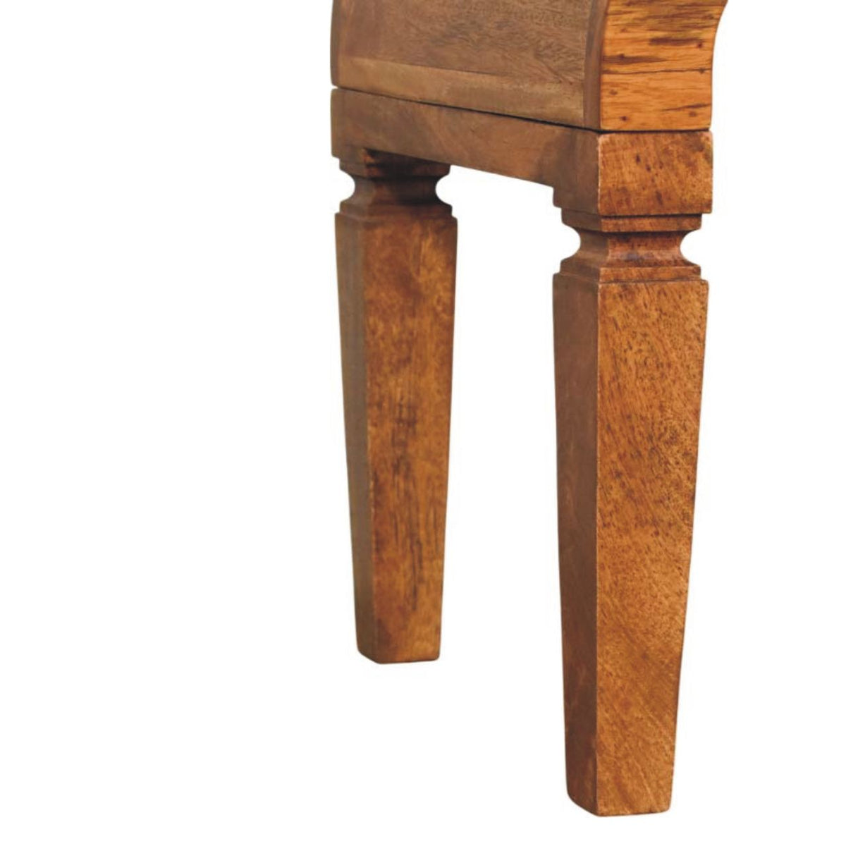 Detail view of the tapered, carved wooden legs on a solid mango wood coffee table in a warm amber oak finish.