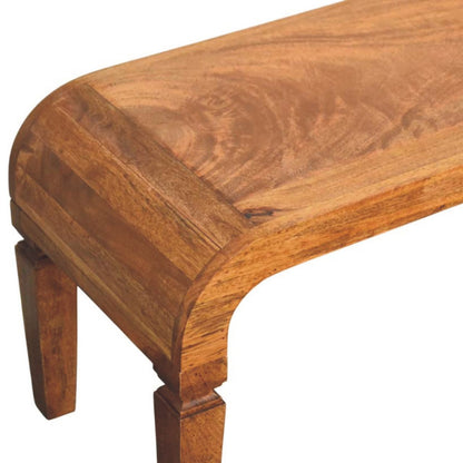 Detail shot emphasizing the rich wood grain and curved waterfall corner of a solid mango wood coffee table.