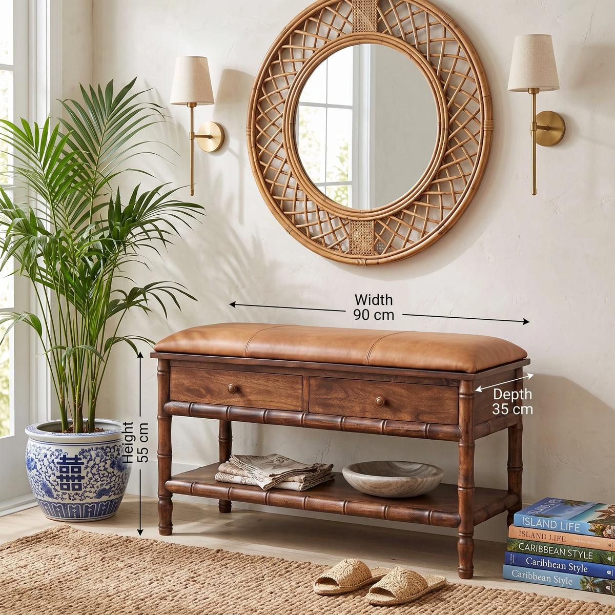 A brown leather bench with bamboo-style legs and shelves, shown in a styled entryway with a large round mirror, wall sconces, a potted plant, and stacked books. White dimension arrows label the bench width as 90 cm and depth as 35 cm, with a height of 55 cm noted beside the plant.