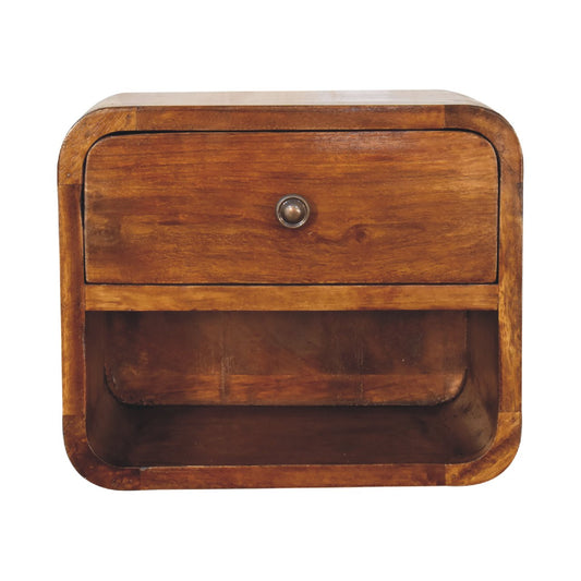 Front view of a wall-mounted solid mango wood bedside table in a chestnut finish, featuring a top drawer with a metal knob above an open storage shelf, framed by rounded corners.