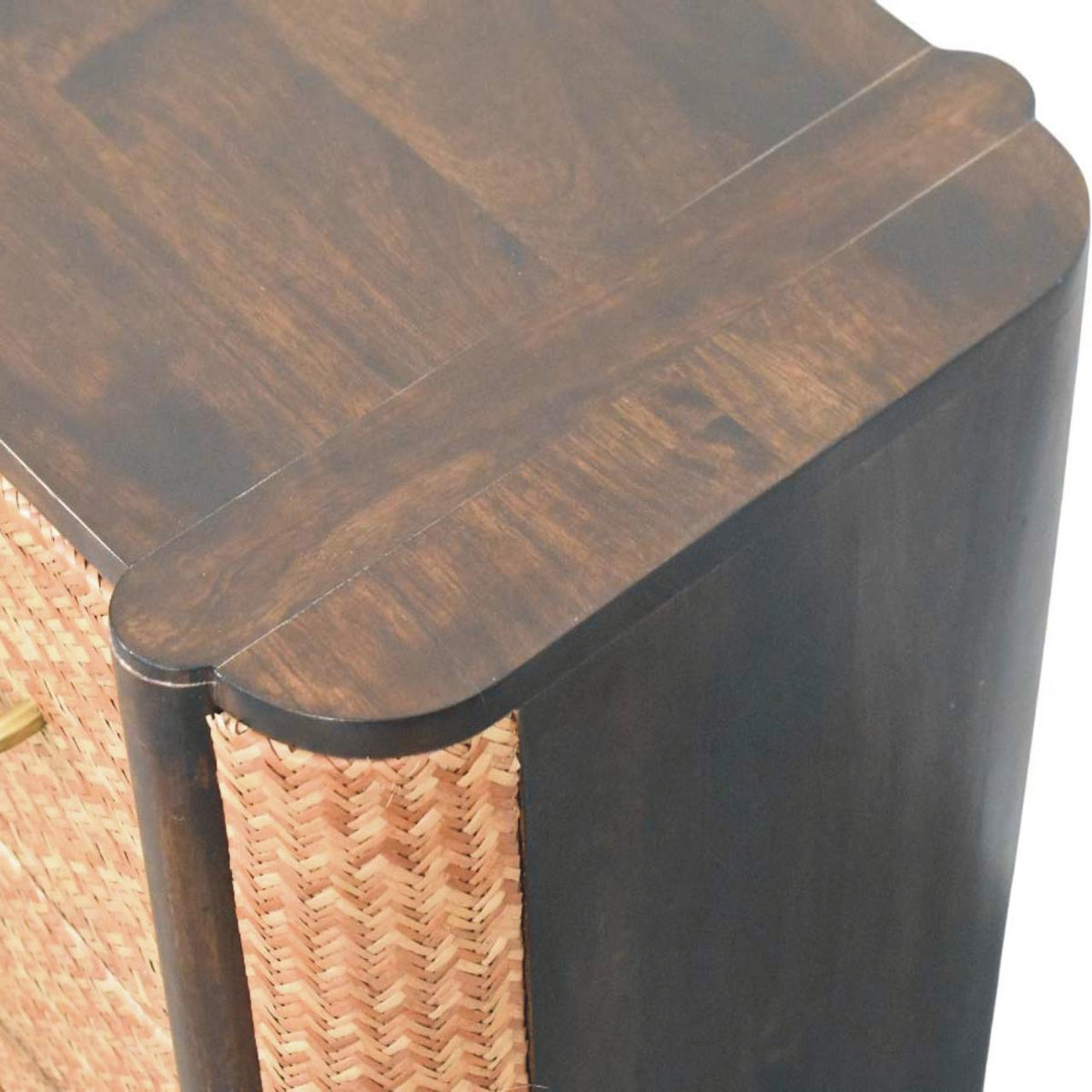 Elevated angled view focusing on the smooth solid mango wood top surface and the woven rattan side panel of a velvet mocha bedside table.