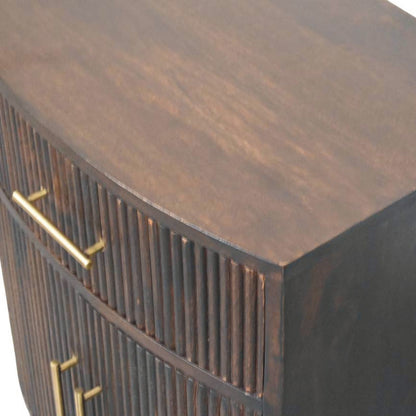 Elevated angled view showing the smooth solid mango wood top surface and curved front edge of a fluted bedside table in velvet mocha.