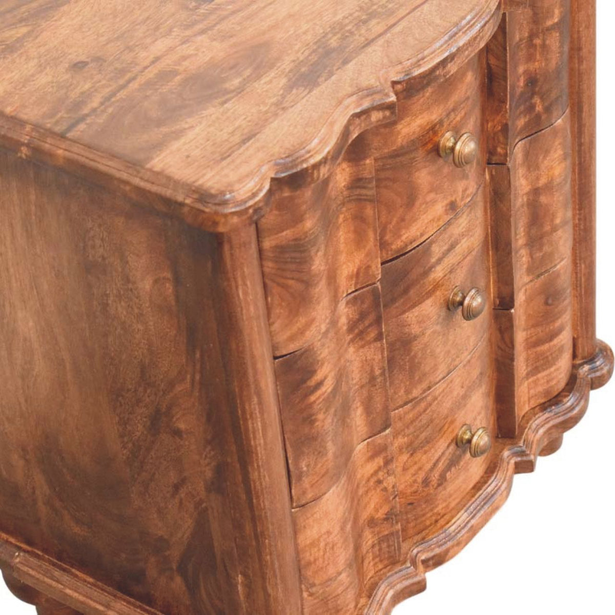Elevated close-up angled view emphasizing the three-dimensional wavy texture on the drawer fronts of a roasted almond bedside table.