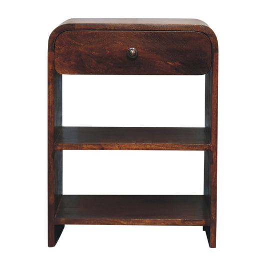 Front view of a solid mango wood bedside table in a chestnut finish, featuring a curved top, one drawer with a metal knob, and two open lower shelves.