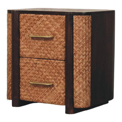 Angled left perspective of a solid mango wood bedside table in velvet mocha, highlighting the woven rattan texture on the drawers and side panel.