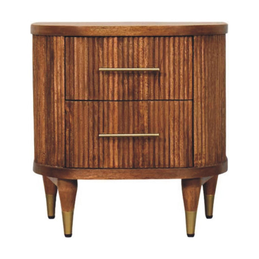 Front view of a 2-drawer solid mango wood bedside table in amber oak, featuring a vertical ribbed texture, curved edges, and brass bar handles.