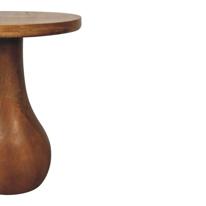 Wooden side table with a round top and curved base on a white background