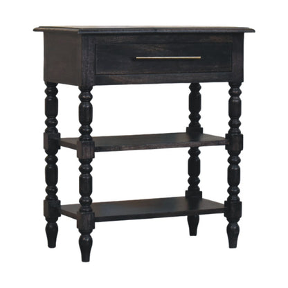 Angled right view of a 1-drawer turned-leg side table made of solid mango wood in a dark carbon ash finish.