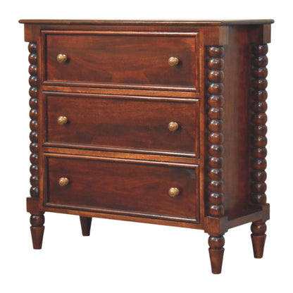 Angled left perspective of a Winewood Oak spindle chest, showcasing the three drawers and the full length of the turned spindle side columns.